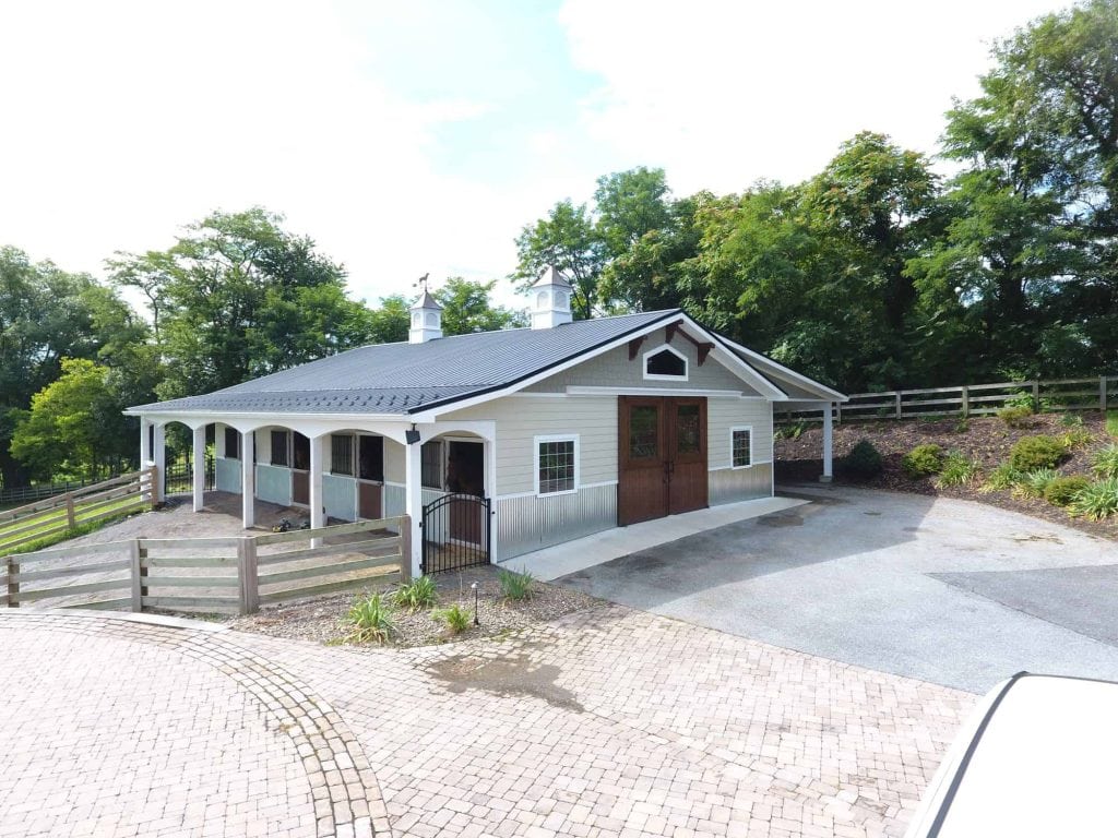 Elegant horse barn and stable designed for equestrian needs, set in scenic Quarry View landscape.