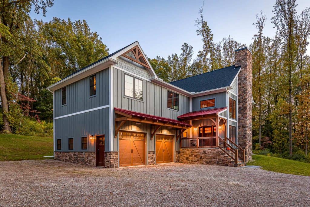 Custom home designed by Quarry View Building Group featuring stone accents, wood siding, and large windows.