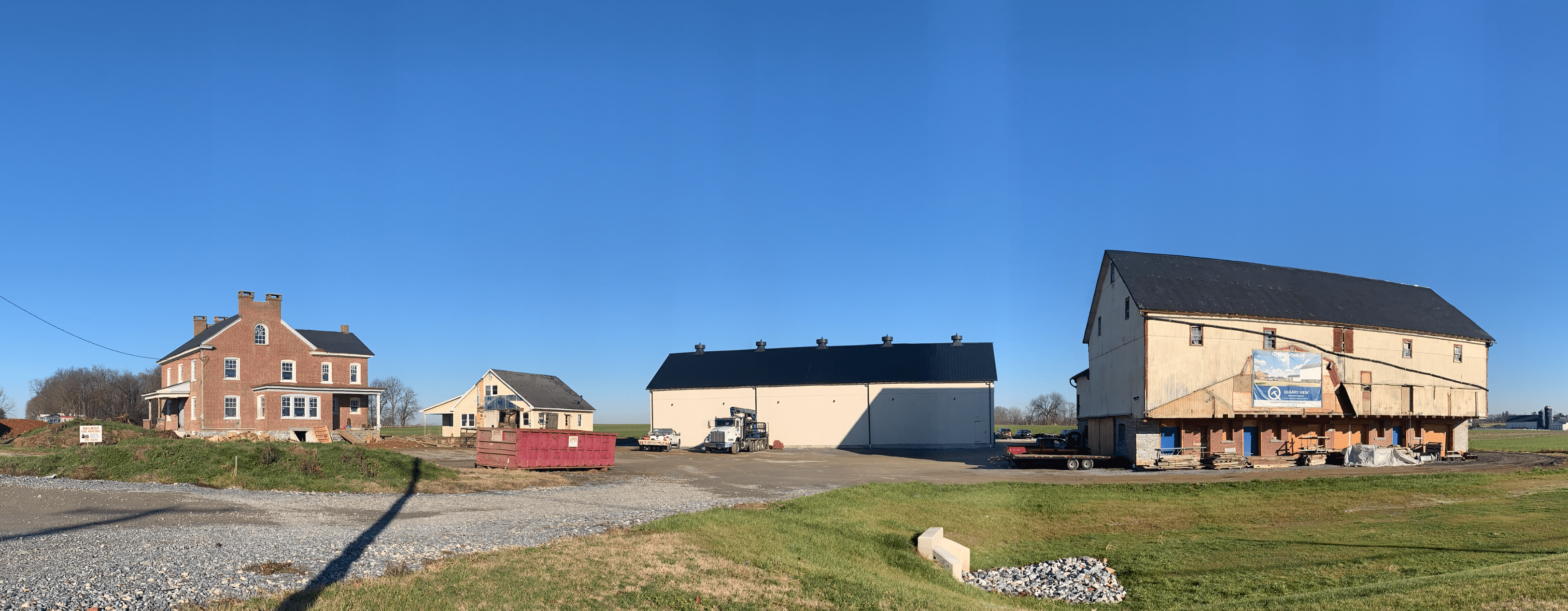 Overview of farmstead with farmhouse and in-laws quarters under construction, newly constructed tobacco barn, and 1911 barn being restored.