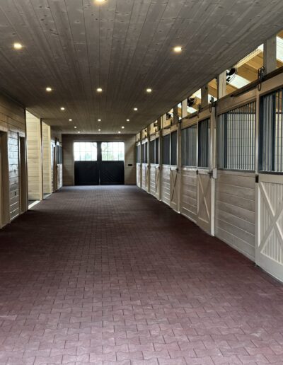 interior view down the hallway of an 8 stall horse barn