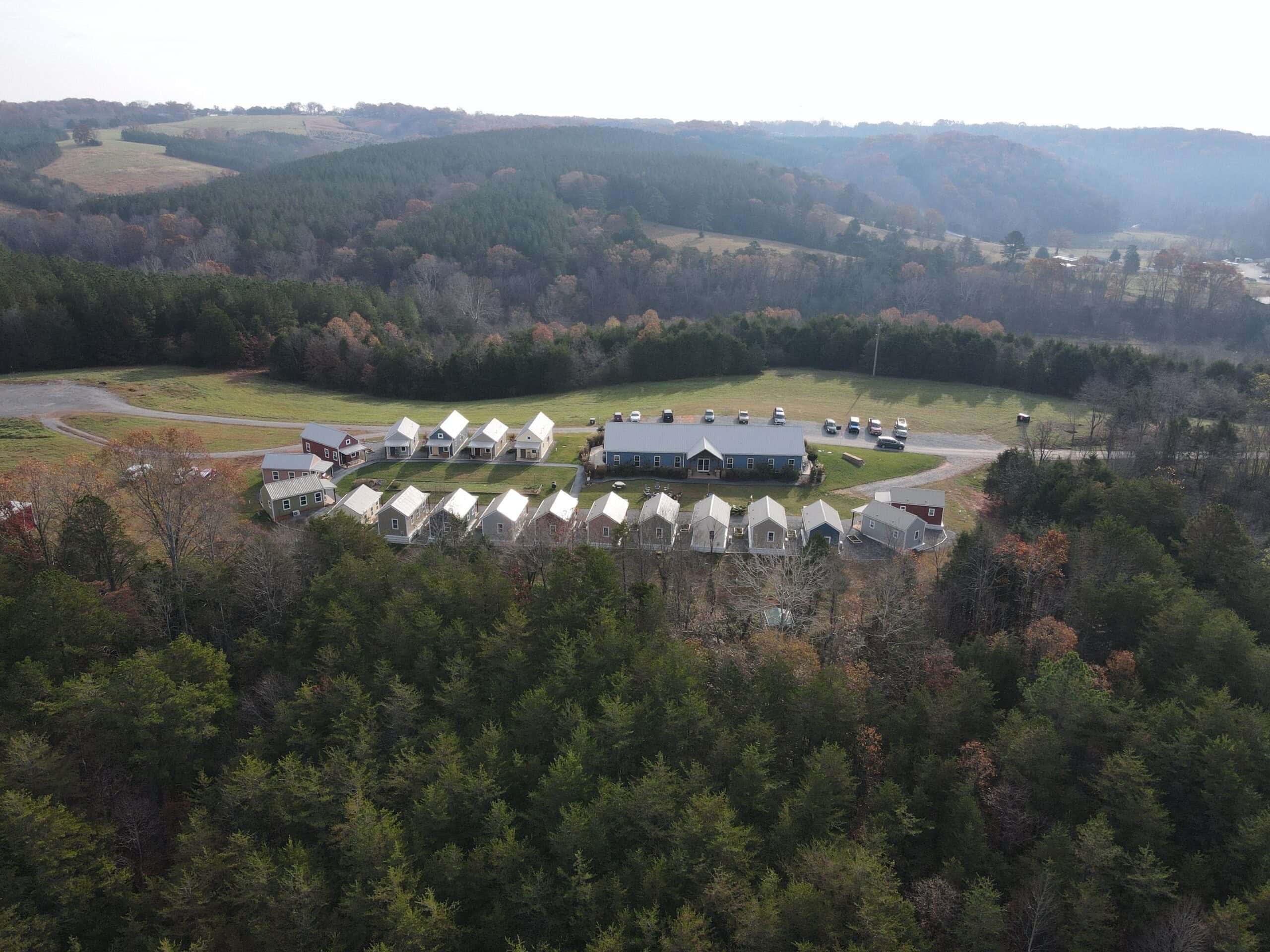Aerial view of Quarry View Buildings group set in scenic hilly landscape with colorful autumn trees.