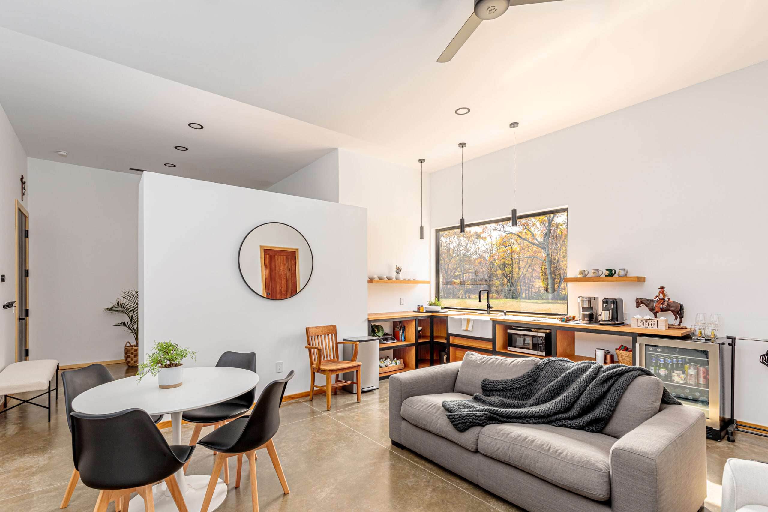 Bright contemporary kitchen with large window overlooking scenic quarry view, ideal for modern home construction.