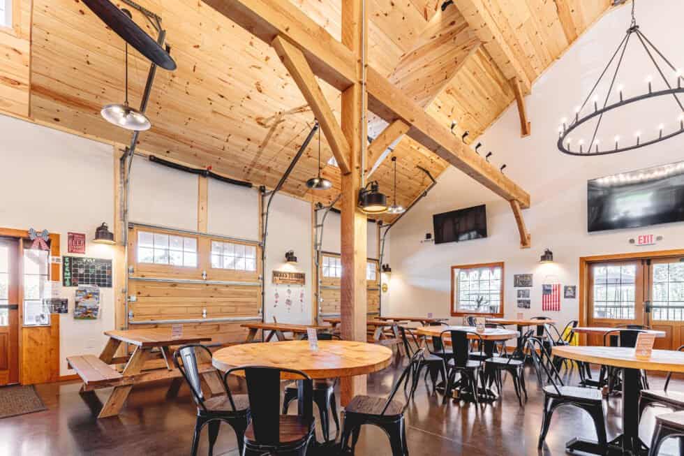 Bright industrial building with wood accents, modern lighting, and seating areas for gatherings.