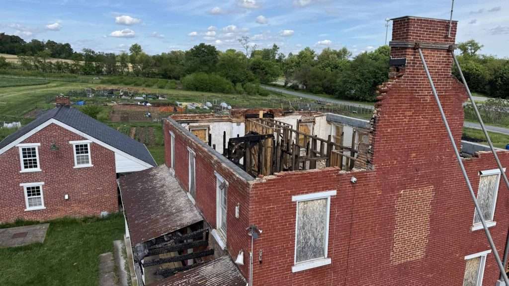 Chimney and brick construction damage, roofing repairs in progress.