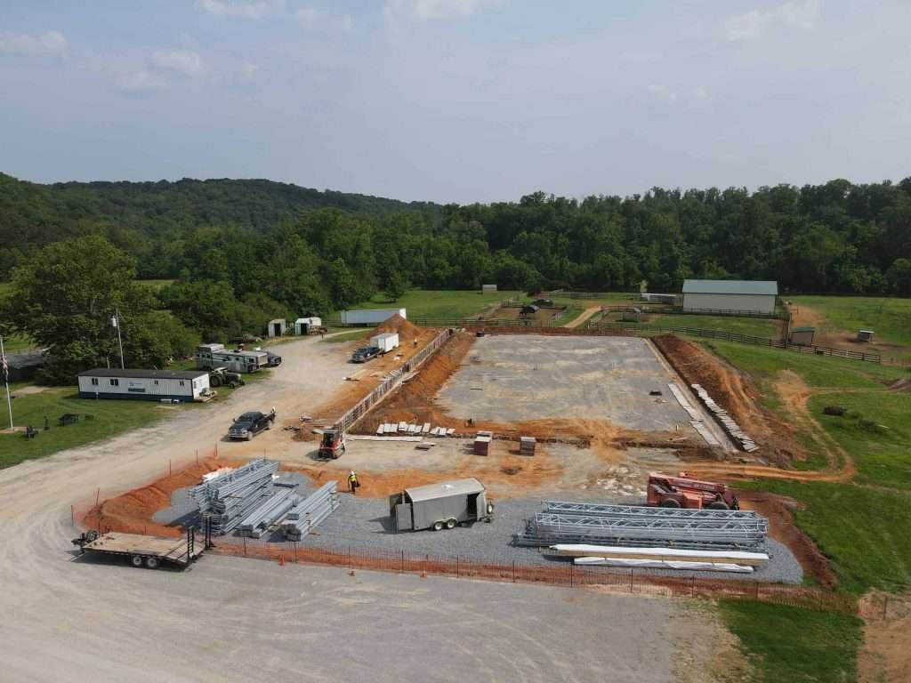 Aerial view of a construction site with foundation preparation for a commercial building by Quarry View Building Group.