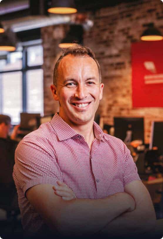 Smiling man in a corporate office environment, representing professional business services.