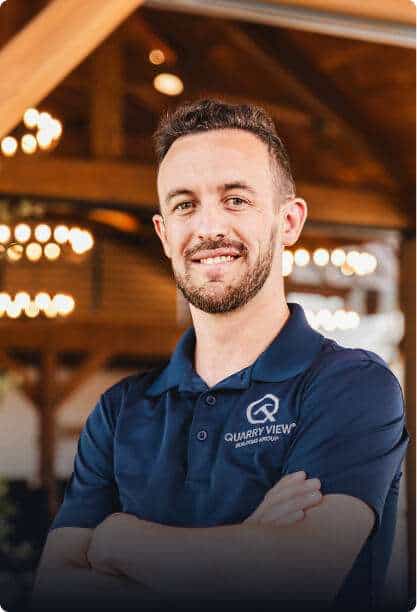 Friendly Quarry View Building Group team member with logo.