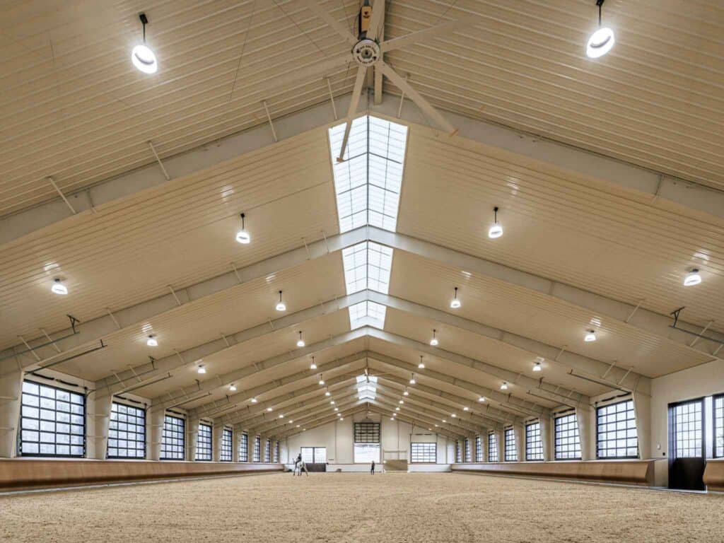 Large 100' x 240' steel indoor riding arena in Virginia with specialized equestrian footing and natural ridge lighting