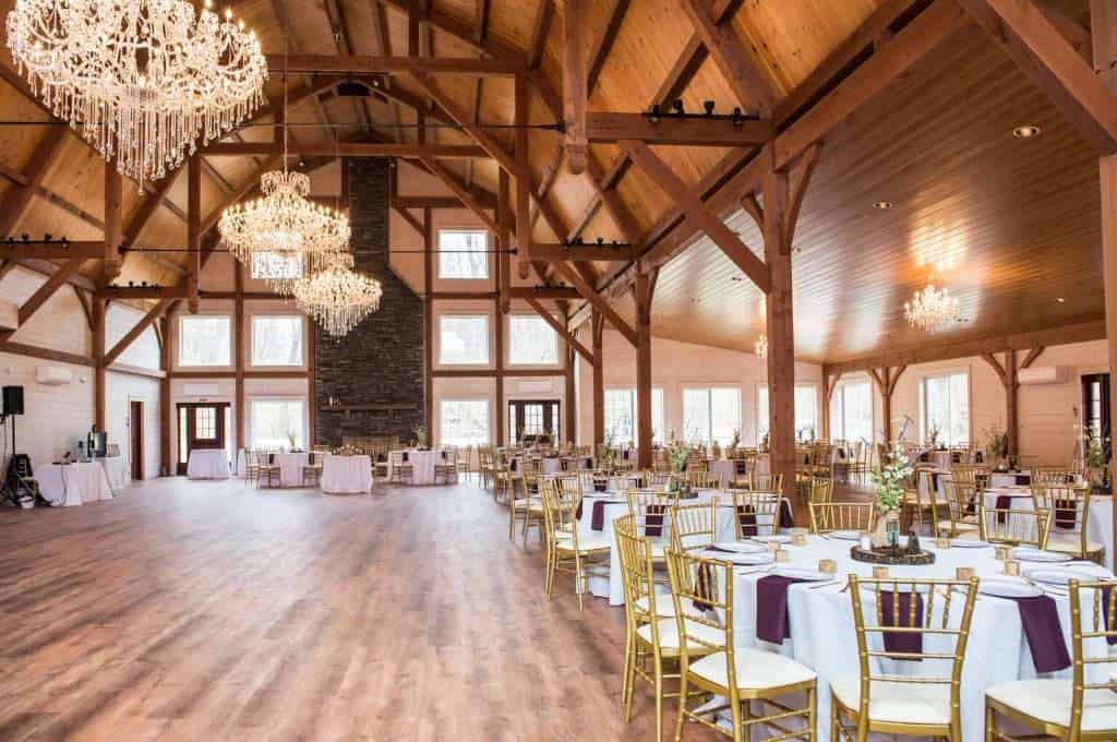 Bright, spacious indoor event venue with high ceilings and rustic wooden accents at Quarry View Building Group.
