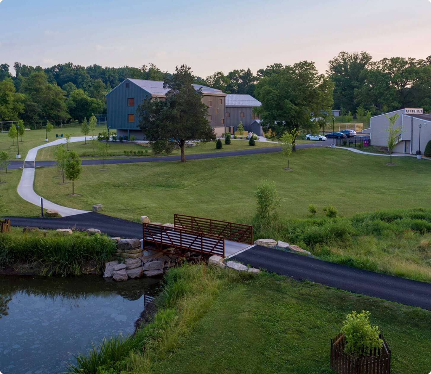 Scenic view of Quarry View Building Group’s modern building amidst lush greenery and walking paths.
