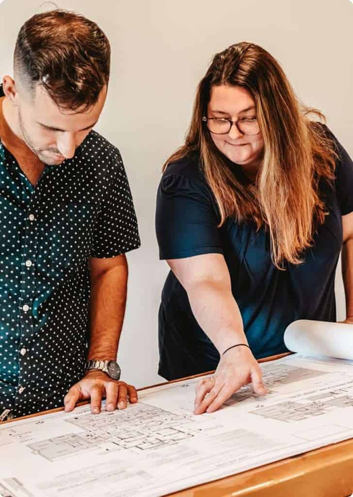 Focused on architectural blueprints and team discussions.