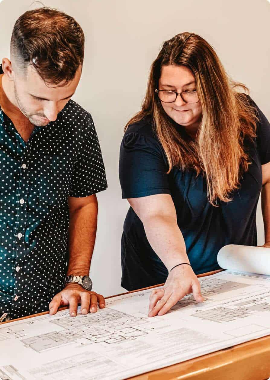 Focused on architectural blueprints and team discussions.