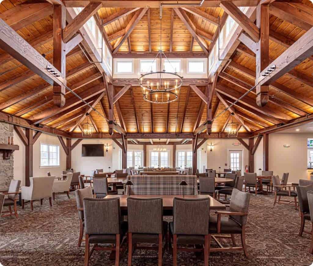 Spacious lodge interior showcasing wooden vaulted ceilings, ample seating, and rustic design.
