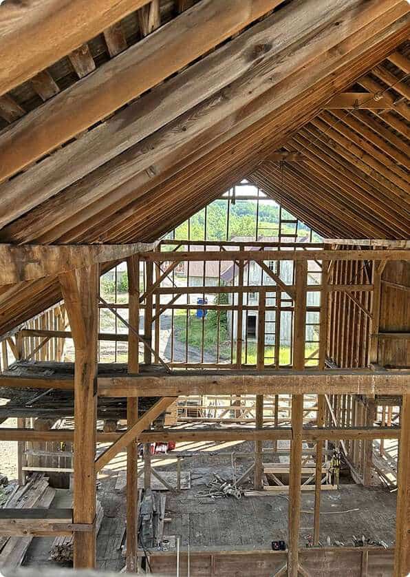 Scaffolded wooden framework under construction for a residential building.