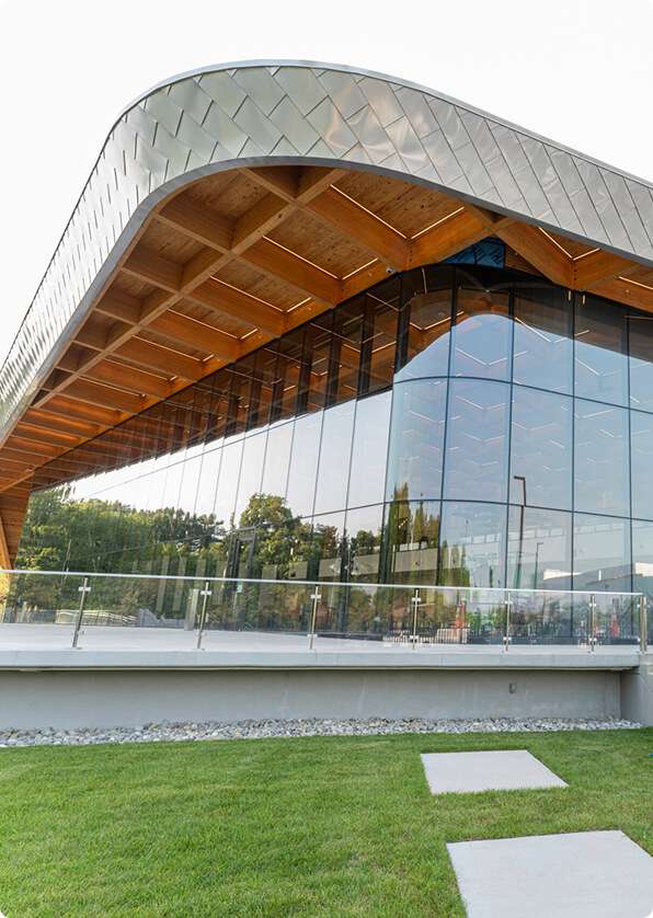 Stunning architecture with glass facade and wooden accents, showcasing innovative design by Quarry View Building Group.