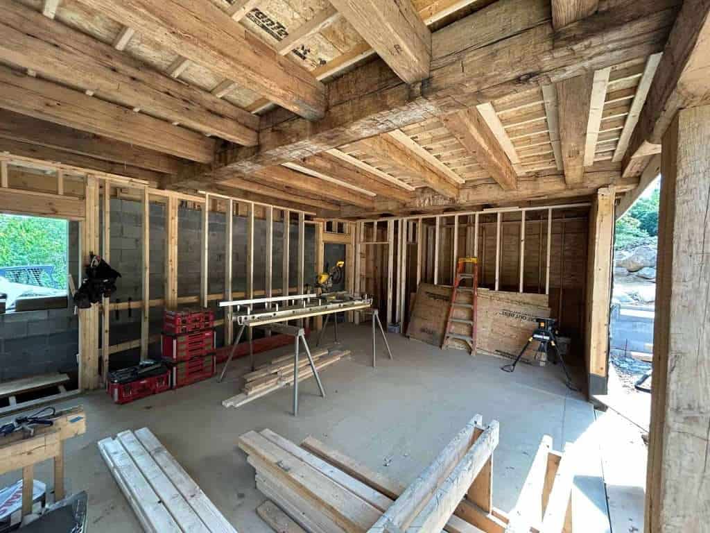Interior timber framing for new home construction, with tools and scaffolding ready for assembly.
