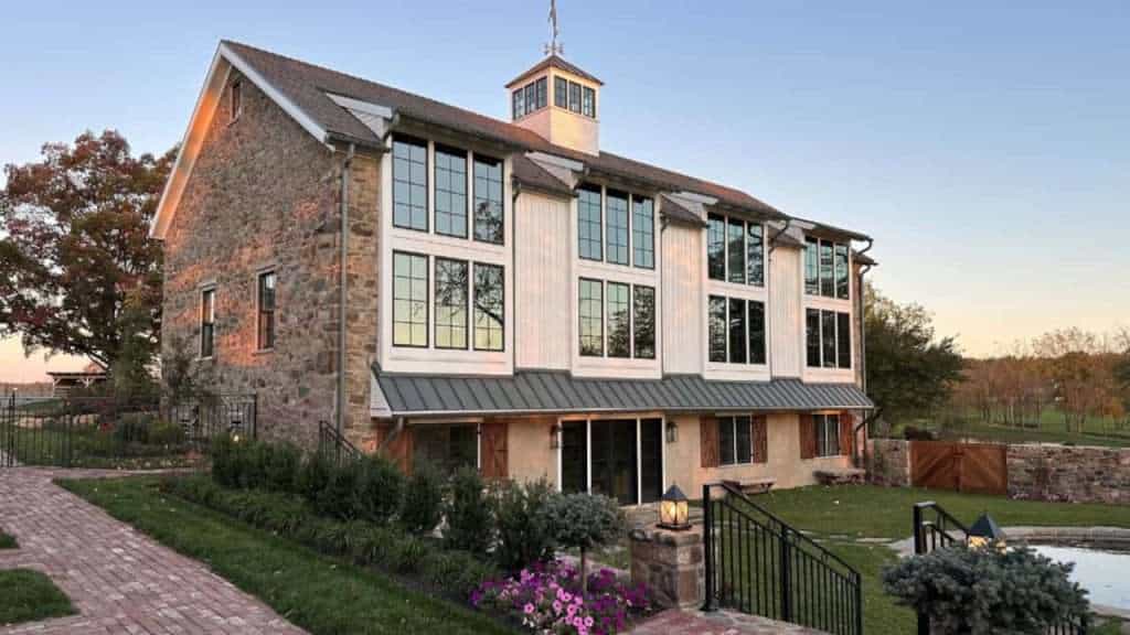 Elegant modern masonry and large windows in a scenic quarry view building. Perfect for luxury home construction.