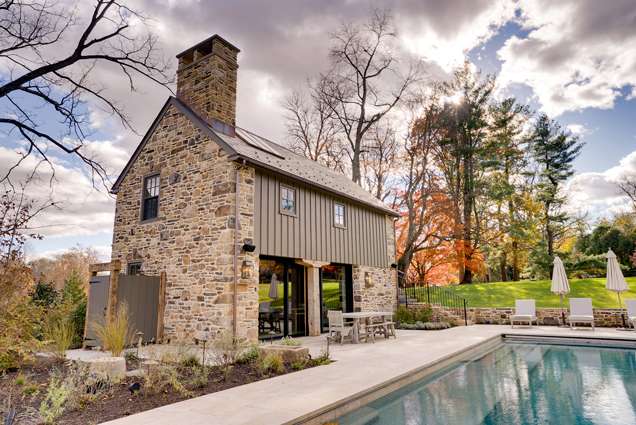Charming stone house with pool and outdoor seating for renovation projects.