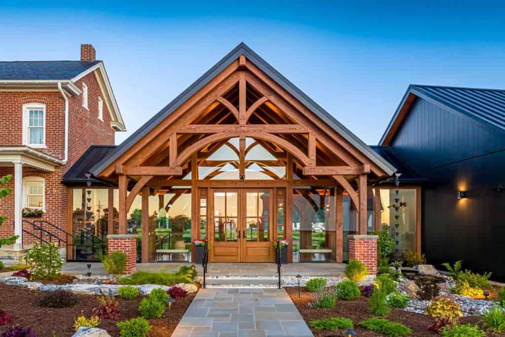 Timber architectural accents enhance the modern building's welcoming entrance.