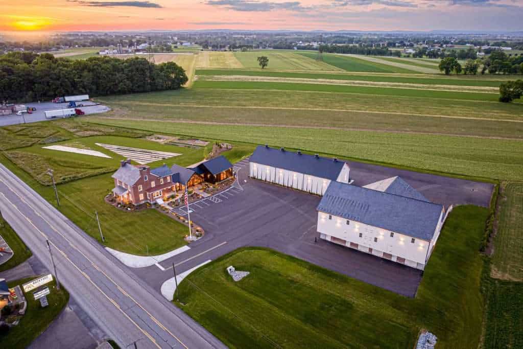 Aerial view of Quarry View Building Group showcasing elegant architecture and landscaped grounds amidst countryside.