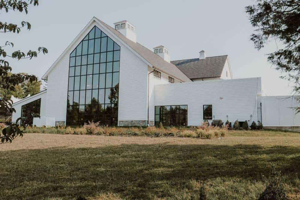 Contemporary commercial building featuring sleek white exterior and expansive glass windows.