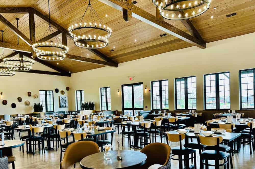 Elegant timber ceiling with chandeliers in a stylish dining space.