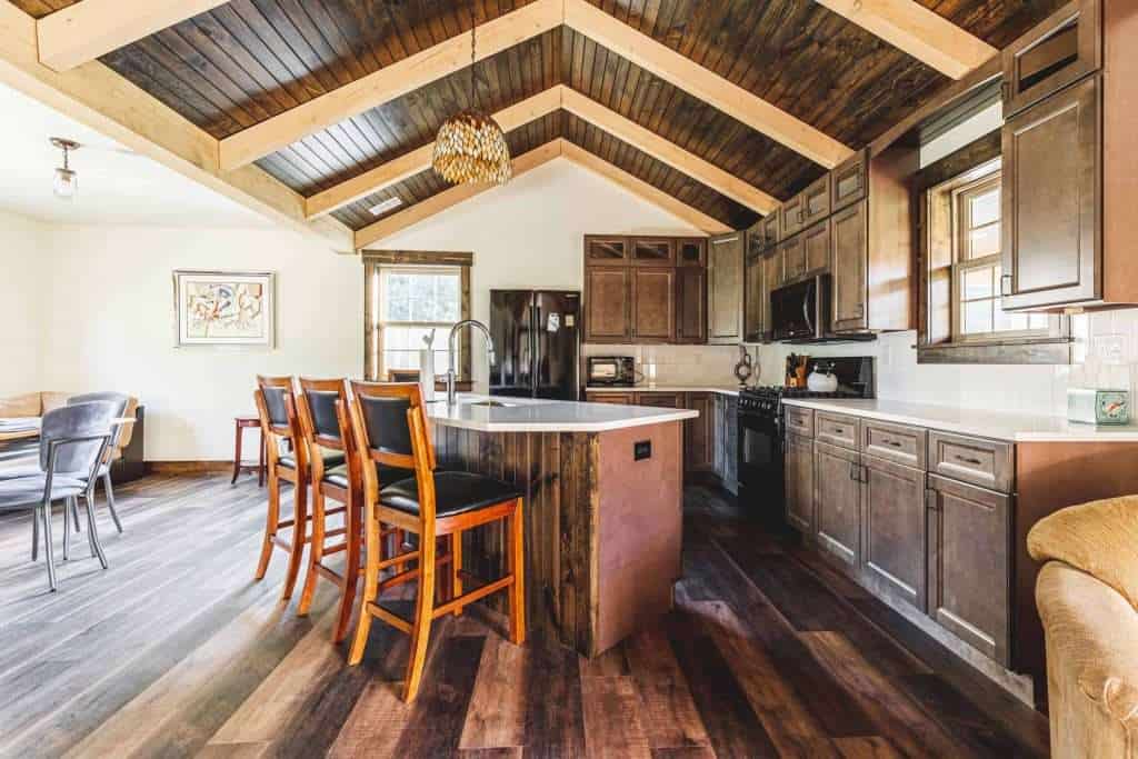 Bright, open-concept kitchen with vaulted ceiling, wooden accents, and contemporary appliances for stylish living.