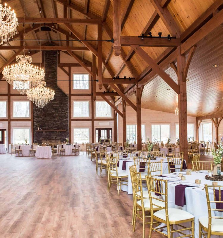 Bright, spacious indoor event venue with high ceilings and rustic wooden accents at Quarry View Building Group.