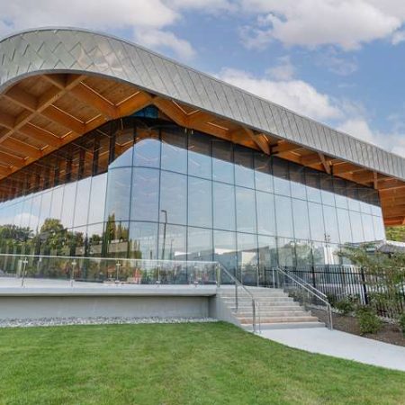 Stunning modern commercial building with glass facade and wooden accents in Quarry View.