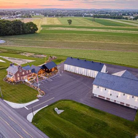 Aerial view of Quarry View Building Group facility in a rural setting with farmland, showcasing construction and building services.